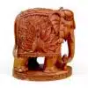 Hand-carved sandalwood elephant figurine with ornate peacock design and decorative base.