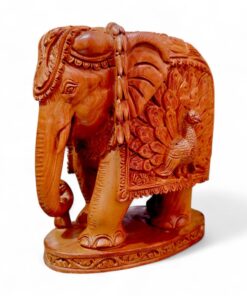 Hand-carved sandalwood elephant statue with peacock design and ornate ceremonial details.