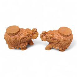 Pair of carved wooden elephant tample base with ornate patterns.