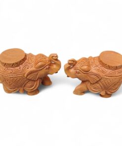 Pair of carved wooden elephant tample base with ornate patterns.