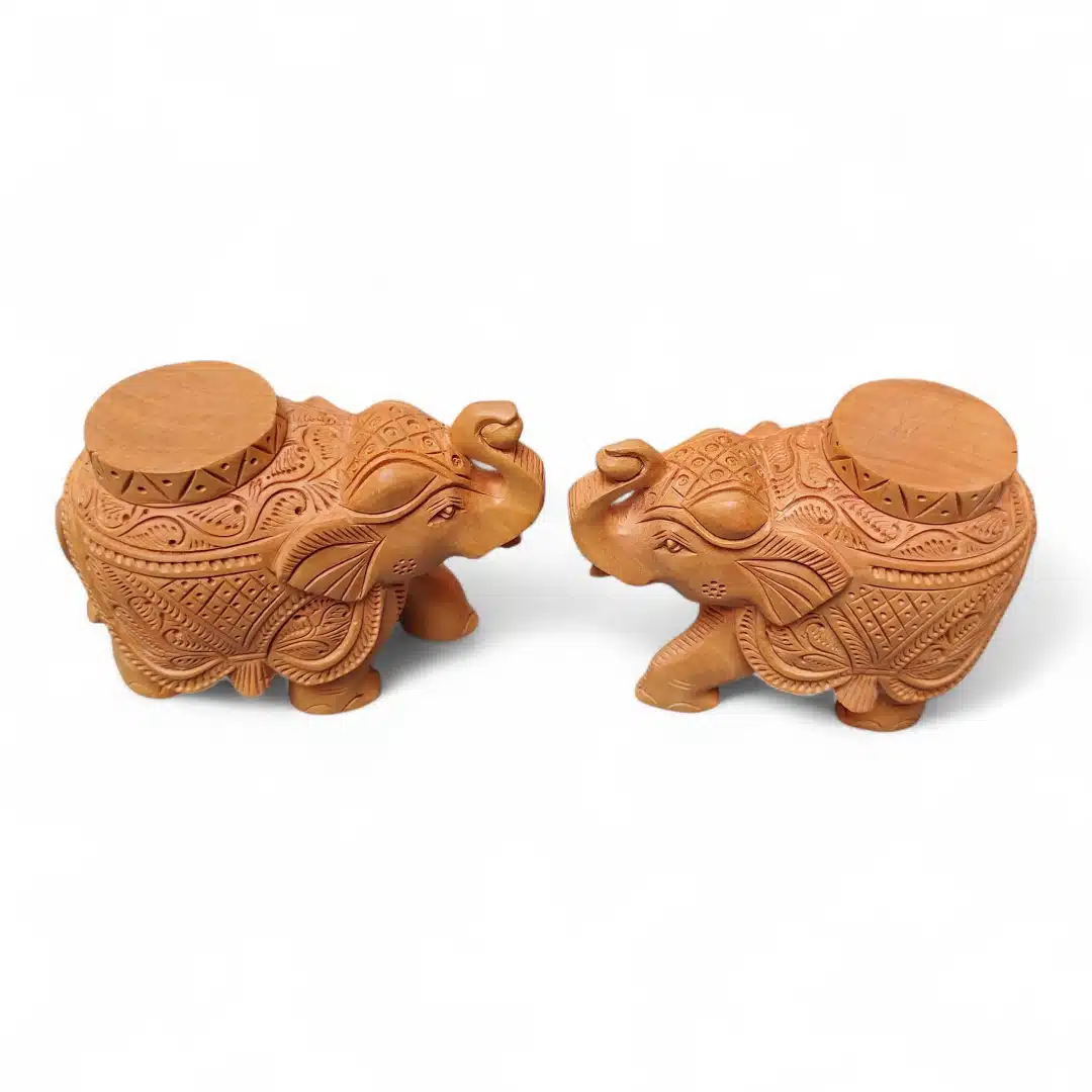 Pair of carved wooden elephant tample base with ornate patterns.