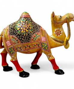 Ornate golden camel figurine with colorful Indian saddle and red legs.