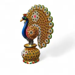 Jeweled decorative peacock figurine with golden fan tail and rhinestone pedestal.