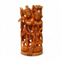 Hand-carved wooden Radha Krishna statue with flute on ornate pedestal.