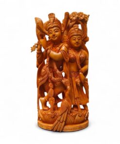 Hand-carved wooden Radha Krishna statue with flute on ornate pedestal.