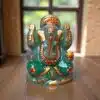 a hand-painted green jade Ganesha statue featuring gold accents