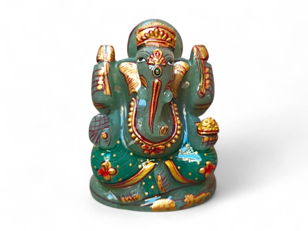 Natural Stone Zade Lord Ganesha statue with gold crown and red floral details.