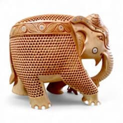 Ornate carved wooden elephant figurine with decorative patterns.