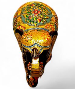 Ornate painted elephant mask with gold floral Indian folk art design.