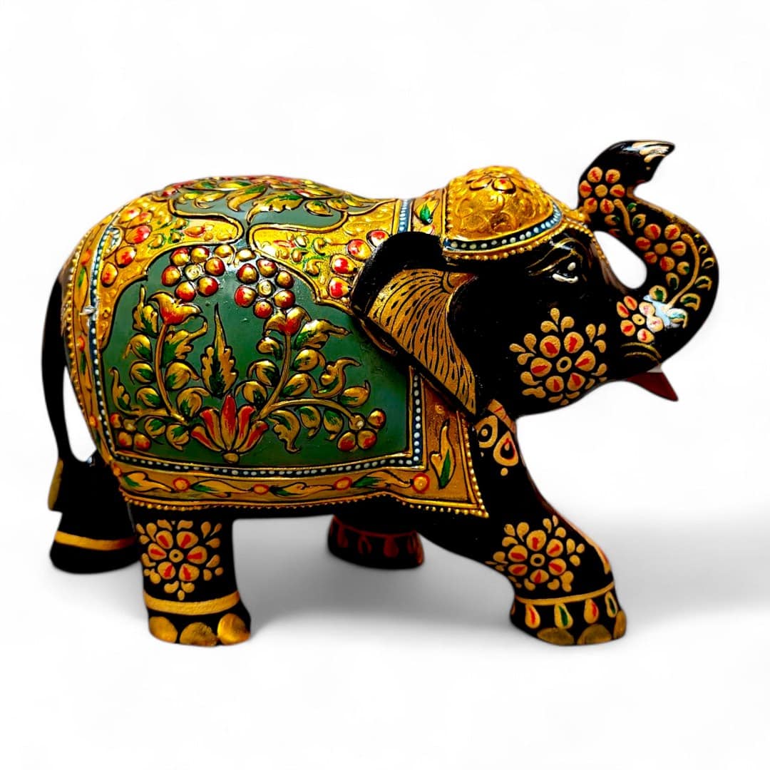 Ornate hand-painted Indian elephant statue with gold, green, and red ceremonial details.