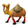 Ornate golden camel figurine with colorful Indian saddle and red legs.