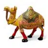 Ornate golden camel figurine with colorful Indian saddle and red legs.