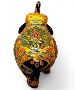Ornate hand-painted elephant figurine with gold floral patterns and raised trunk.