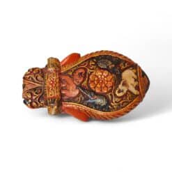 Ornate hand-painted antique vessel with carved mask, floral motifs, and traditional folk art.