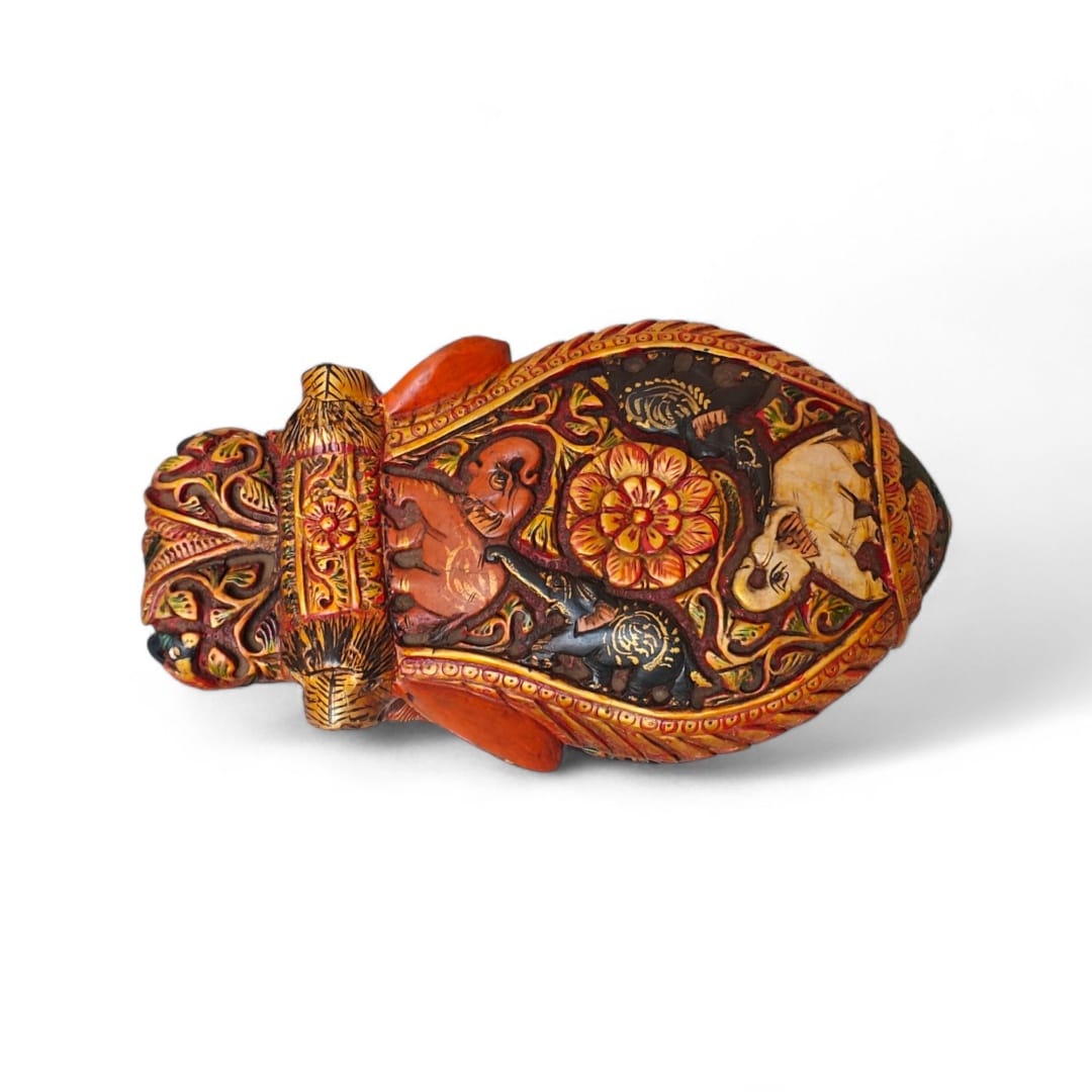 Ornate hand-painted antique vessel with carved mask, floral motifs, and traditional folk art.