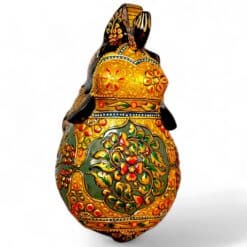 Ornate hand-painted rabbit figurine with glossy gold floral folk art details.
