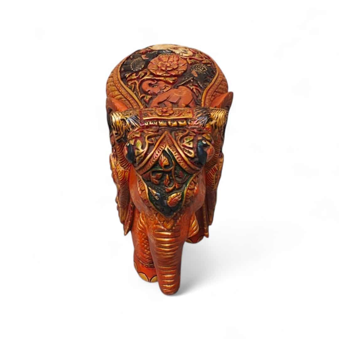 Ornate painted elephant figurine with gold floral saddle on white background.