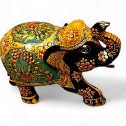 Ornate hand-painted Indian elephant figurine with raised trunk and gold floral decorations.