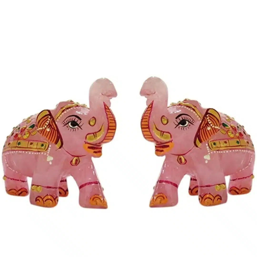 Pink decorative elephant figurines with ornate Indian-style painted details.