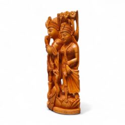 Polished South Asian devotional carving of two crowned figures on ornate pedestal.