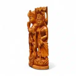 Polished South Asian devotional carving of two crowned figures on ornate pedestal.