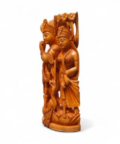 Polished South Asian devotional carving of two crowned figures on ornate pedestal.