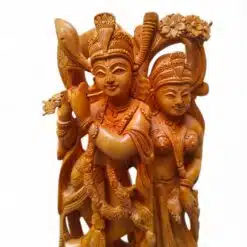 Wooden Radha Krishna flute sculpture with ornate Hindu devotional carving.