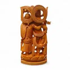 Ornate wooden carving of Radha Krishna figures with halos on lotus pedestal.