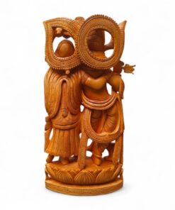 Ornate wooden carving of Radha Krishna figures with halos on lotus pedestal.