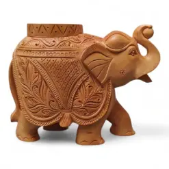 Carved wooden Indian tample piller elephant figurine with raised trunk and floral patterns.