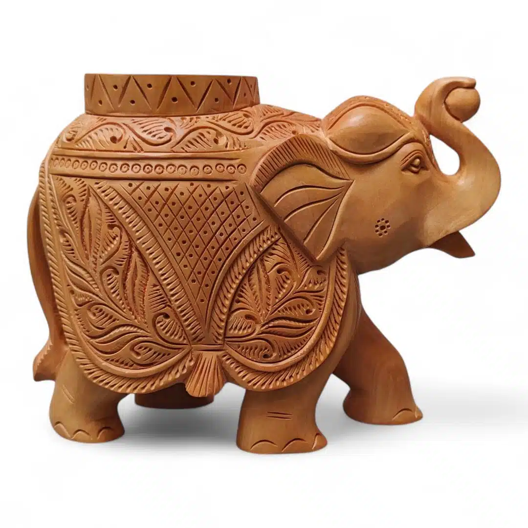 Carved wooden Indian tample piller elephant figurine with raised trunk and floral patterns.