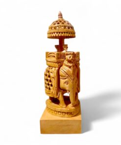 Hand-carved wooden ceremonial elephant statue with ornate canopy and pedestal.