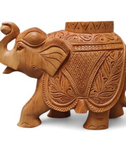 Hand-carved wooden elephant sculpture with raised trunk and ornate floral saddle decor.