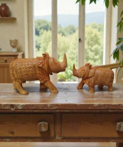 hand-carved wooden rhino statue on a table
