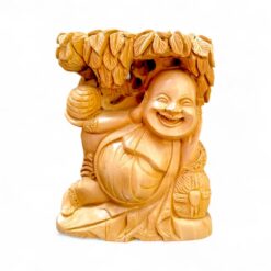 Polished wooden Laughing Buddha figurine with leafy canopy and joyful smile.