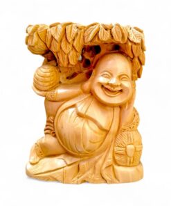 Polished wooden Laughing Buddha figurine with leafy canopy and joyful smile.