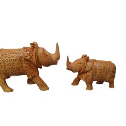 Hand-carved wooden rhinoceros figurines with intricate circular patterns.