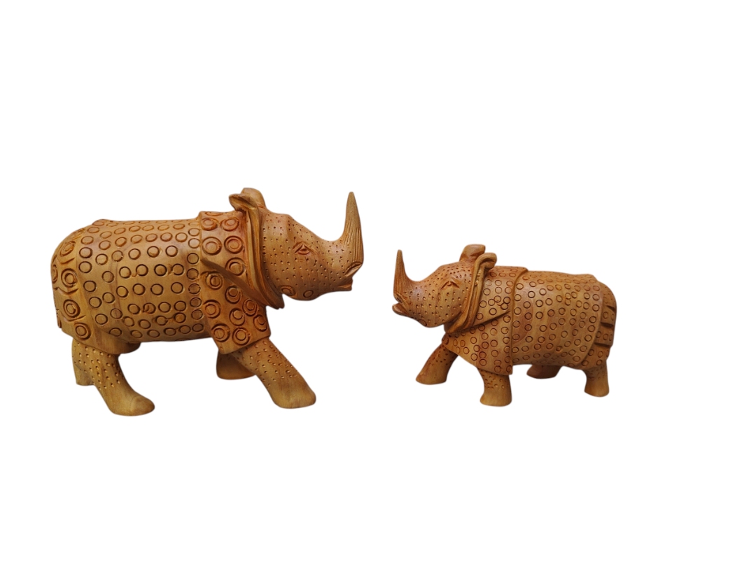 Hand-carved wooden rhinoceros figurines with intricate circular patterns.