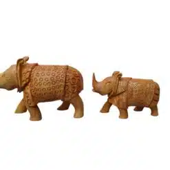 Handcrafted wooden rhinoceros figurines, carved brown rhino sculptures with tribal patterns.