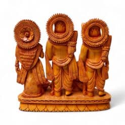 Back view of hand-carved wooden Hindu deity trio with ornate halos.
