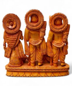 Back view of hand-carved wooden Hindu deity trio with ornate halos.