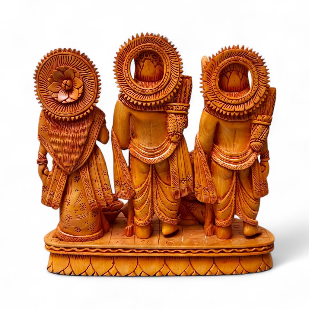 Back view of hand-carved wooden Hindu deity trio with ornate halos.