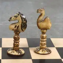 Handcrafted bone animal chess pieces on a black and light wood chessboard.