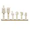 Hand-carved bone chess set with animal-shaped bone pieces on wooden base.