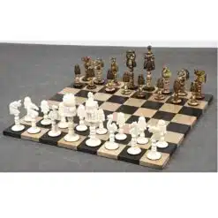 Luxury fantasy chess set with ornate camel bone and bronze pieces on wooden board.