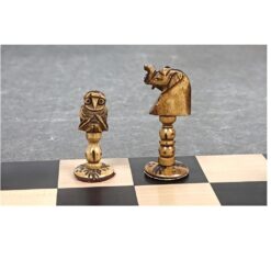 Handcrafted wooden owl and knight chess pieces on a classic chessboard.